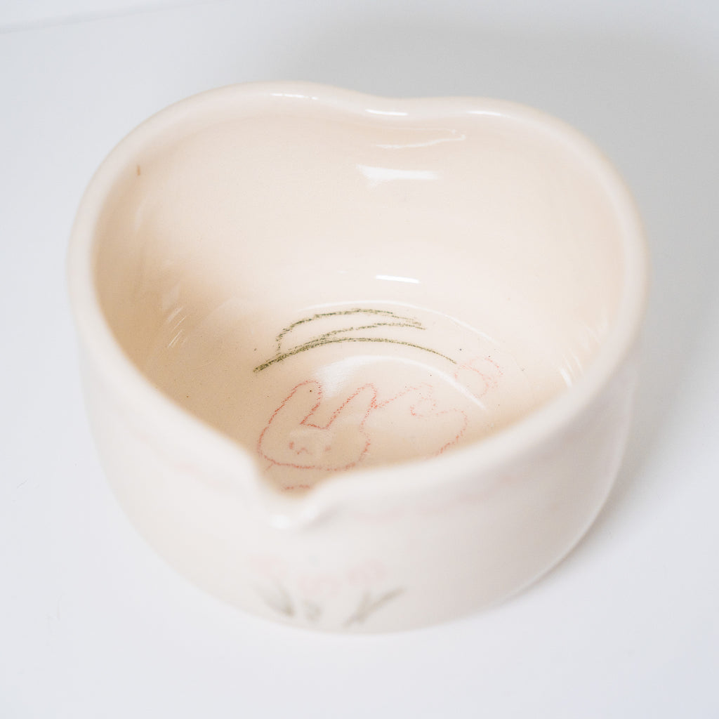 Ceramic matcha bowl with floral design on a white background