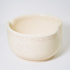 Ceramic matcha bowl with floral design on a white background