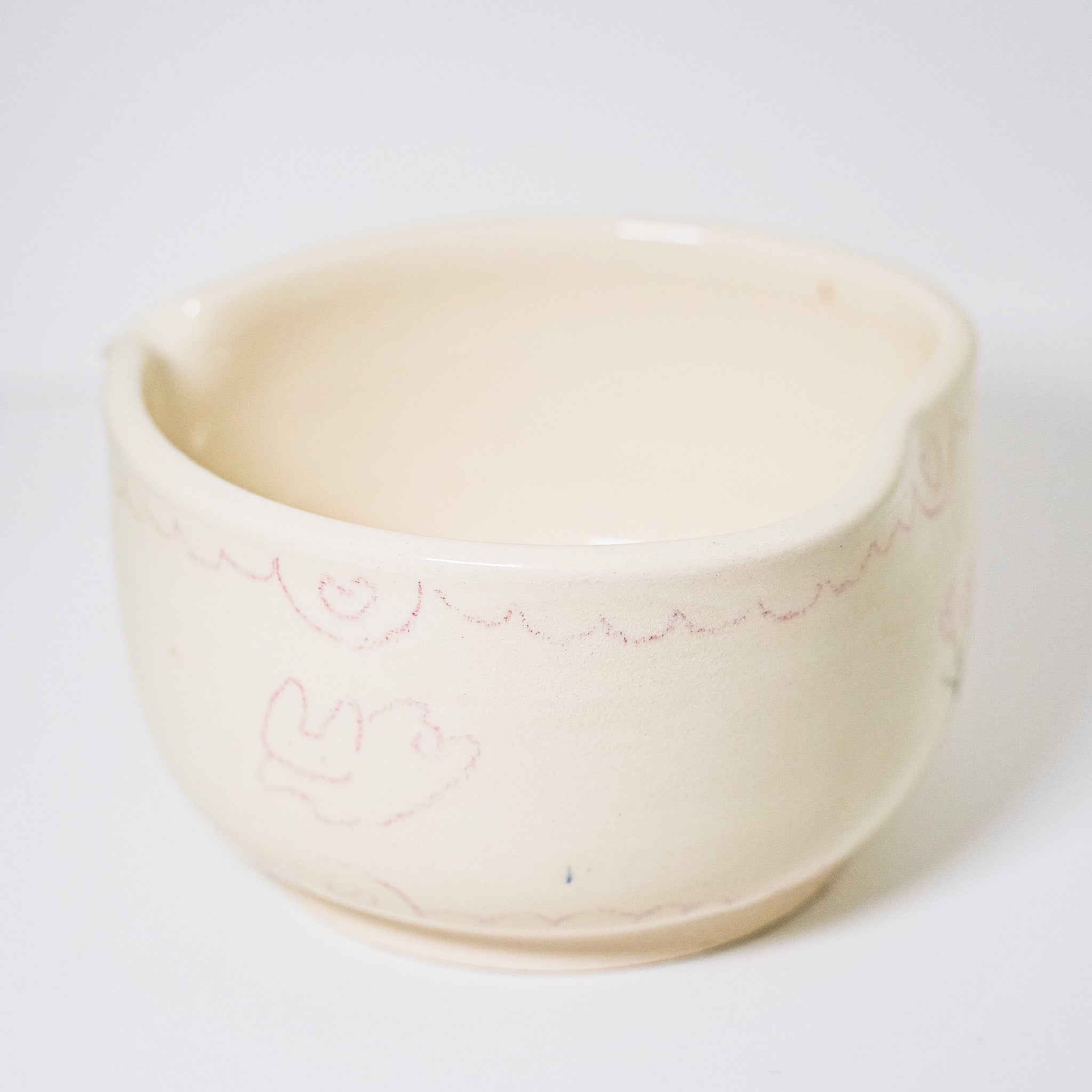 Ceramic matcha bowl with floral design on a white background
