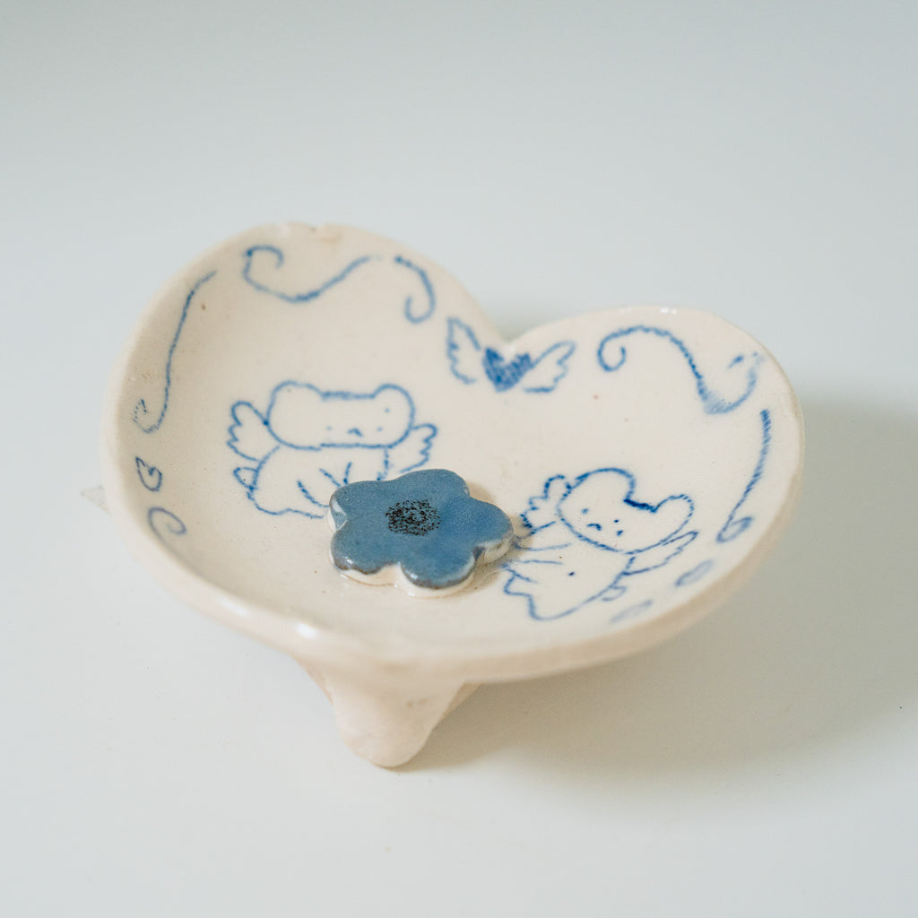 Heart-shaped ceramic dish with blue floral design on a white background