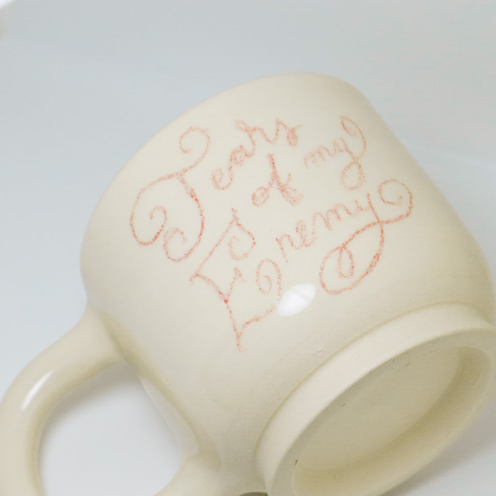 White mug with red text on a light gray background