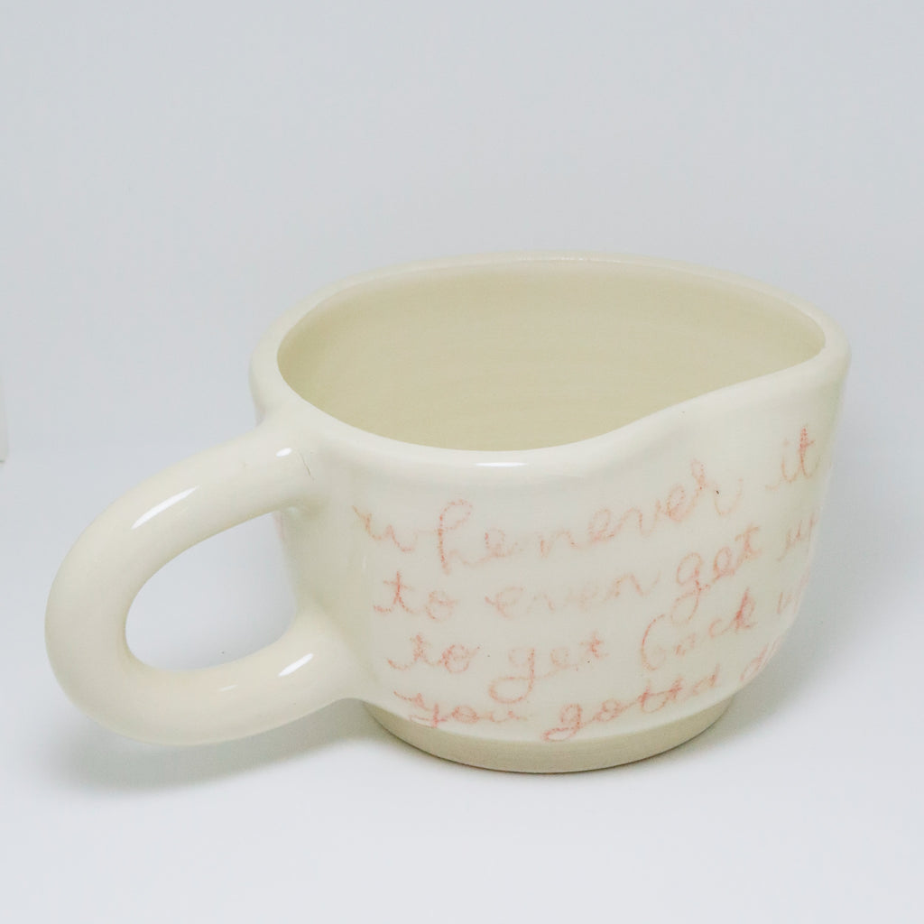 White mug with red text on a white background