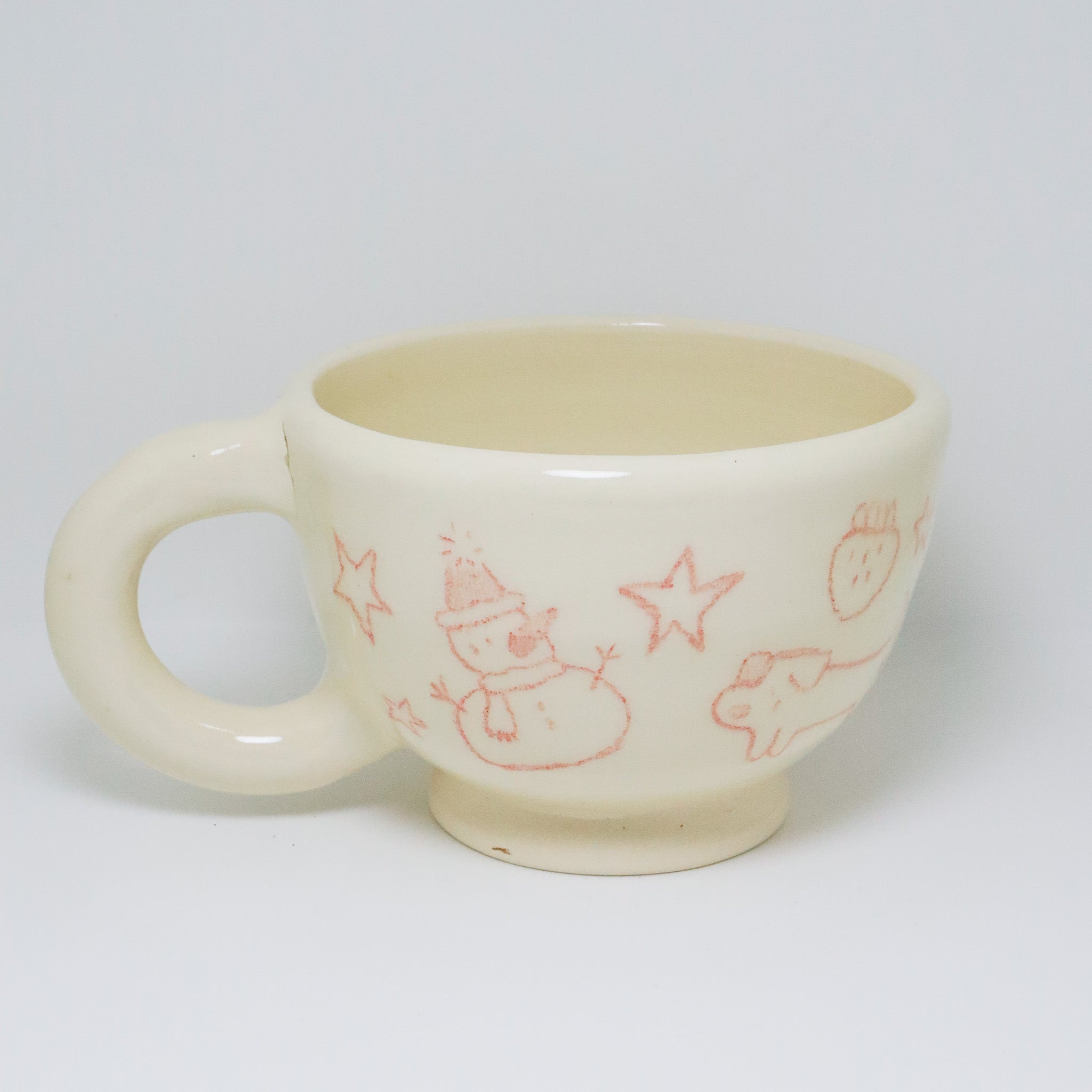 White ceramic mug with red illustrations on a white background