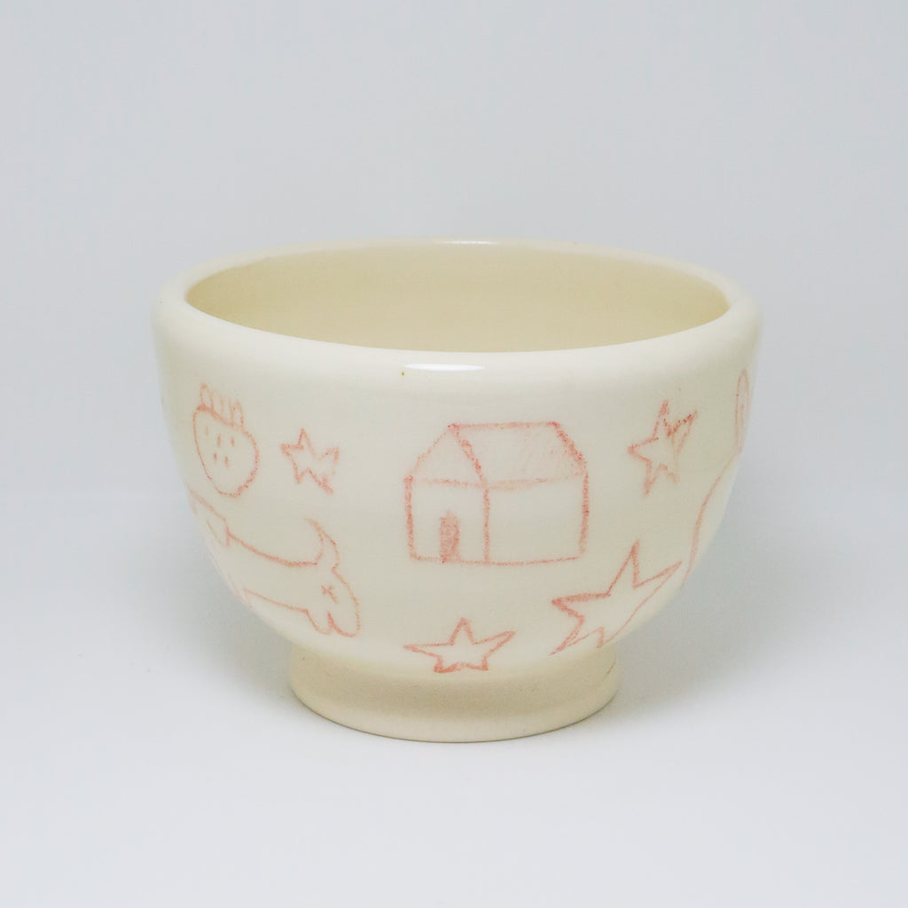 Ceramic cup with red line drawings on a white background