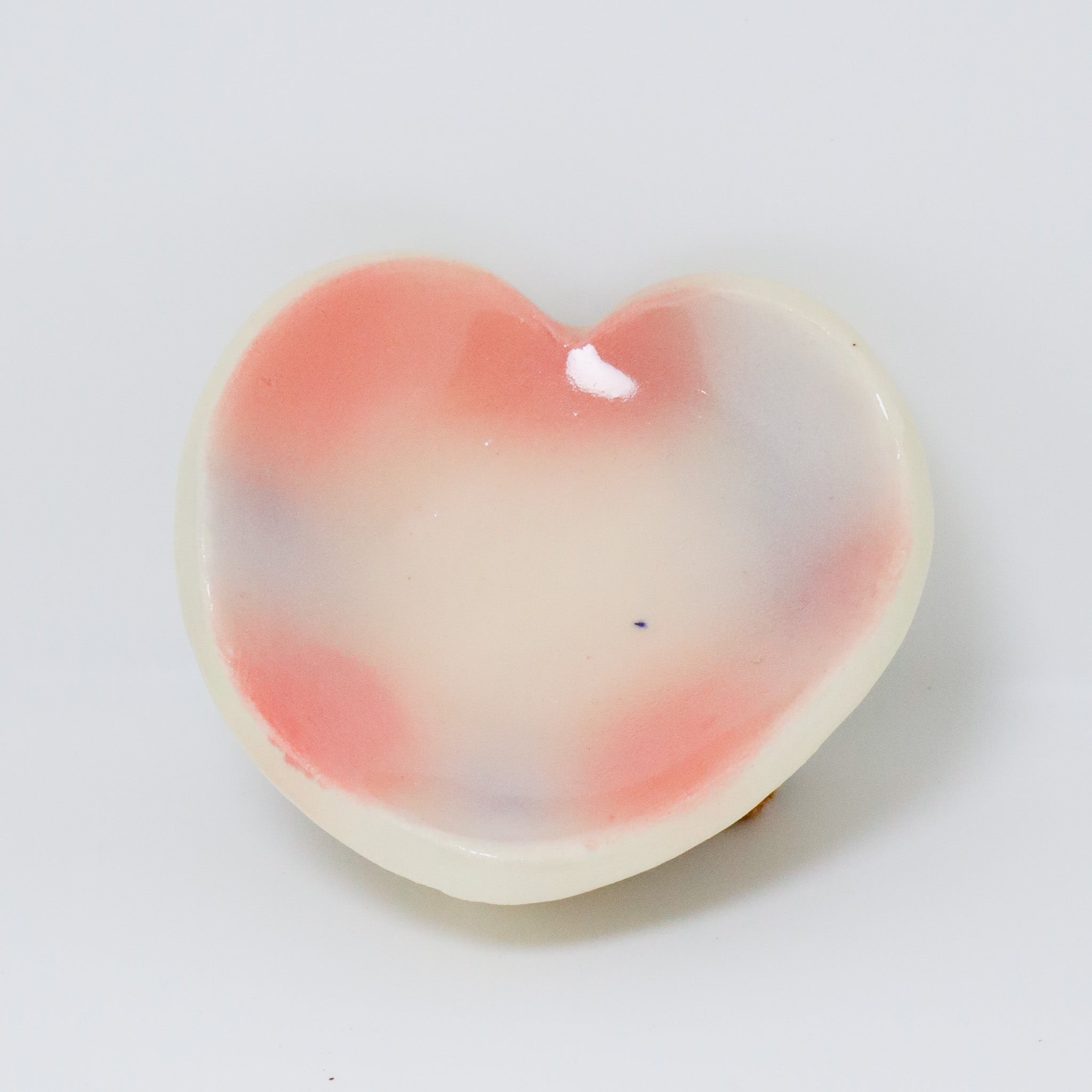 Heart-shaped object with gradient color on a white background