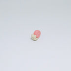 Small figurine of a snail on a light gray background