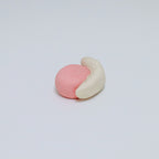 Pink and beige ceramic snail on a light gray background