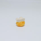 Small ceramic bee on a light gray background