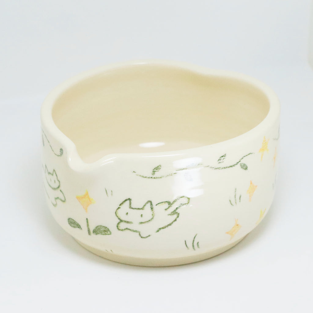 Ceramic bowl with cat illustrations on a white background