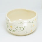 Ceramic bowl with cat illustrations on a white background