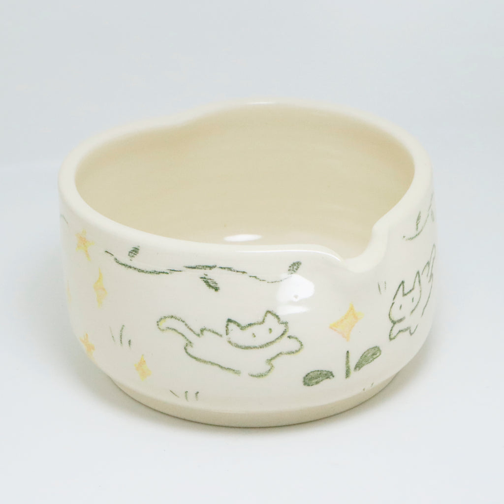 Ceramic bowl with cat illustrations on a white background