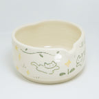 Ceramic bowl with cat illustrations on a white background