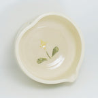 Small ceramic dish with floral design on a white background