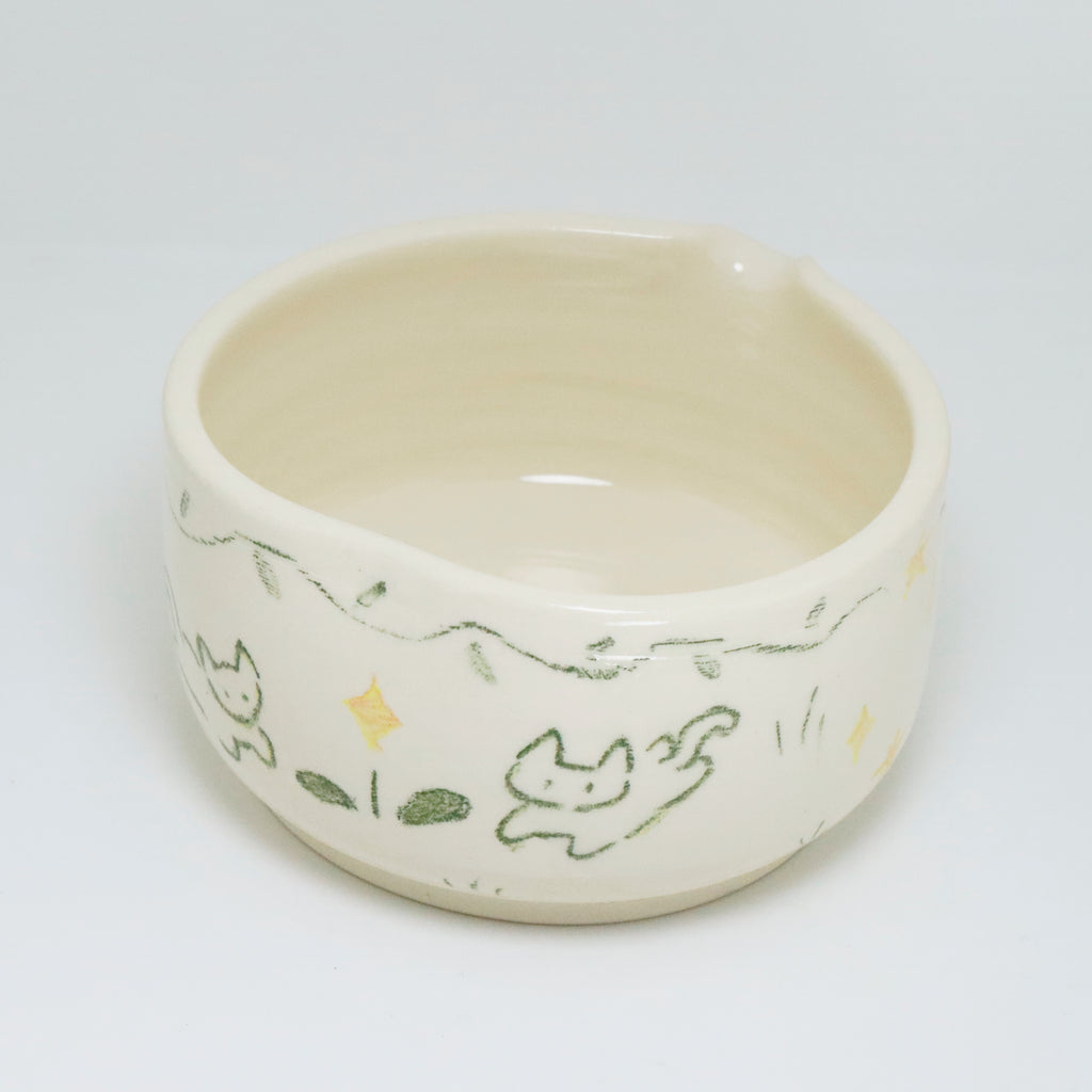 Ceramic bowl with cat illustrations on a white background