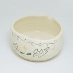 Ceramic bowl with cat illustrations on a white background