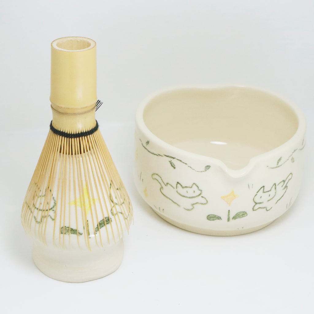 Ceramic whisk and bowl set with cat illustrations on a white background